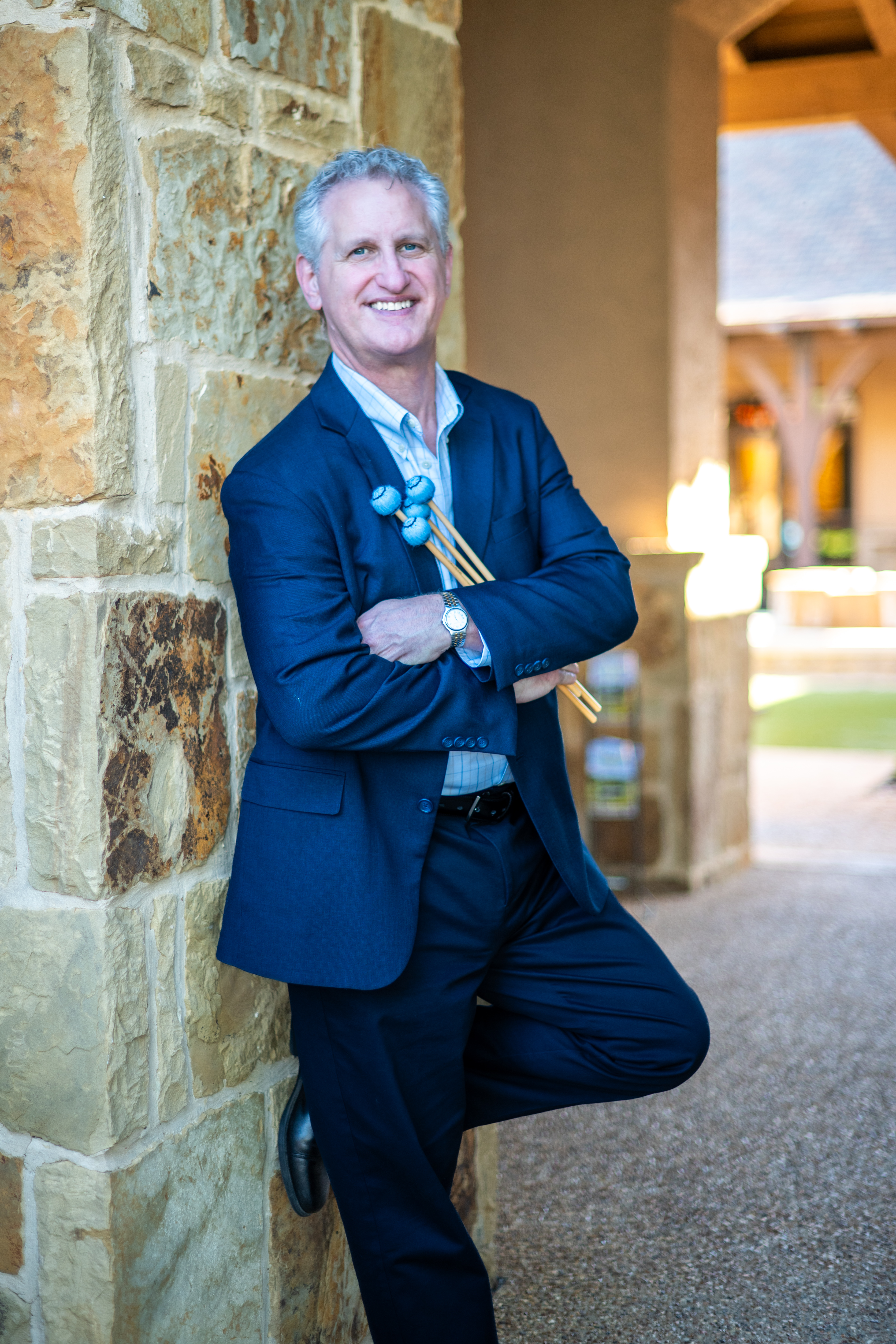 Tim McCormick — Jazz vibraphonist and vocalist, holding mallets in a blue suit