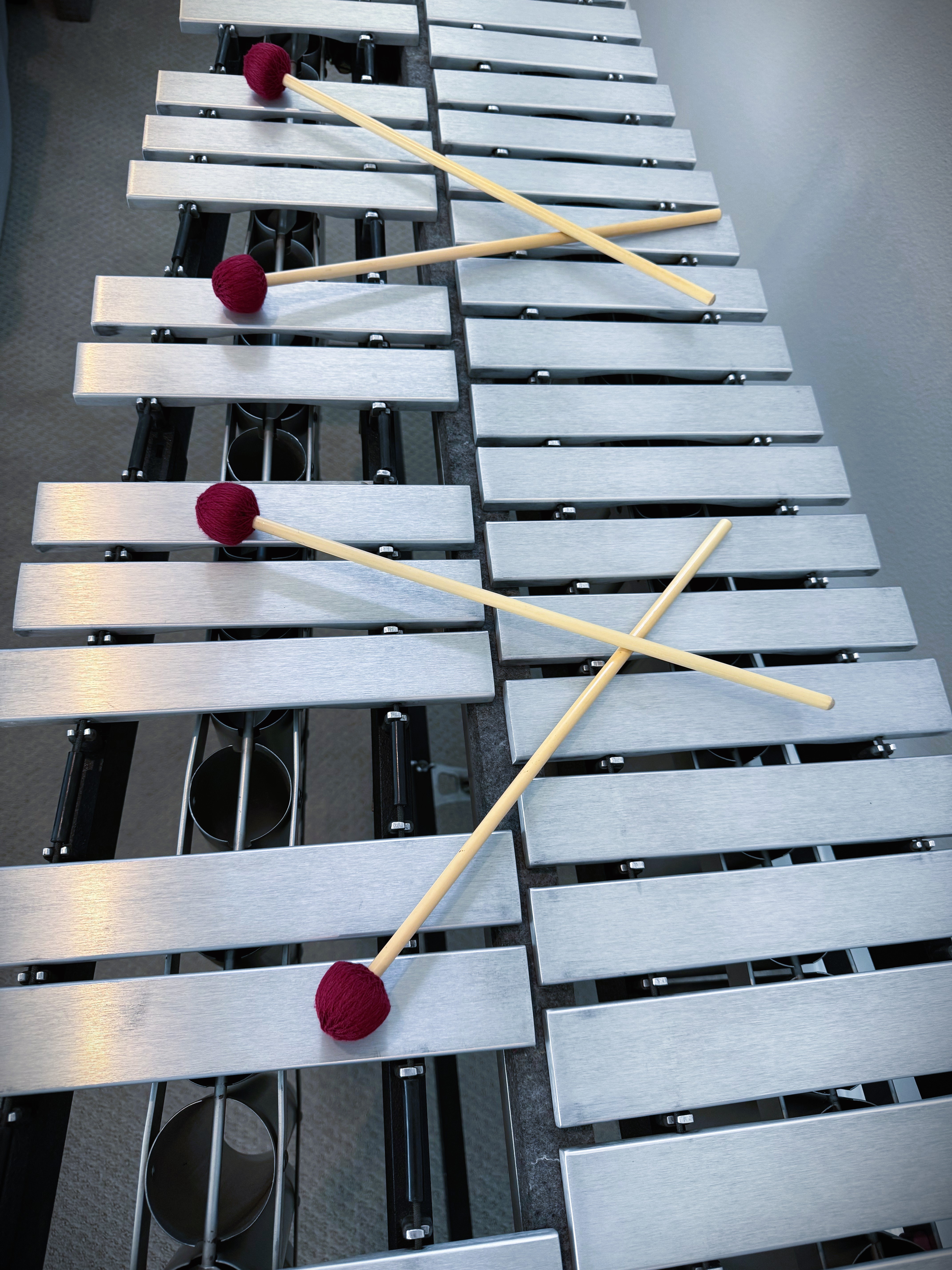 Close-up of vibraphone bars with four crossed mallets